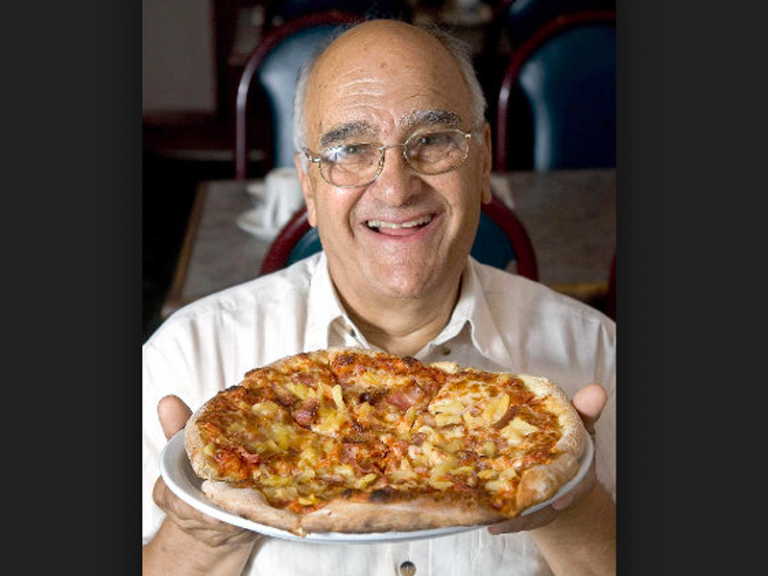 A century later, a 20-year-old Greek named Sam Panopoulos found himself similarly disappointed. Stopping in Naples during a 1954 voyage to Canada, he found his first taste of “pizza” — a bun topped with sauce and spaghetti — uninspiring. Yet Mr. Panopoulos, who opened a restaurant in Chatham, Ontario, called Satellite, eventually warmed to the yeasted flatbread that Neapolitan bakers had popularized in the 1700s and that Greek chefs had whipped up for sailors more than a thousand years before. Searching for new pizza flavors one day in 1962, he reached for a can of fruit and launched a culinary revolution, topping his restaurant’s standard cheese pizza with bits of ham and pineapple. The result was sweet, sour and savory — a flavor combination hailed ever since as both revelatory and repugnant, a Canadian treasure and a “Polynesian perversion.”