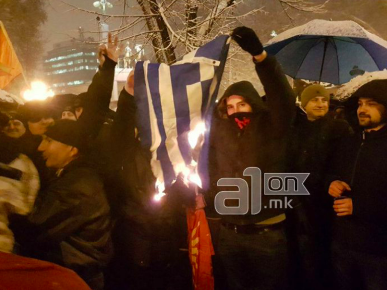 Protestors march in Skopje burning Greek flag