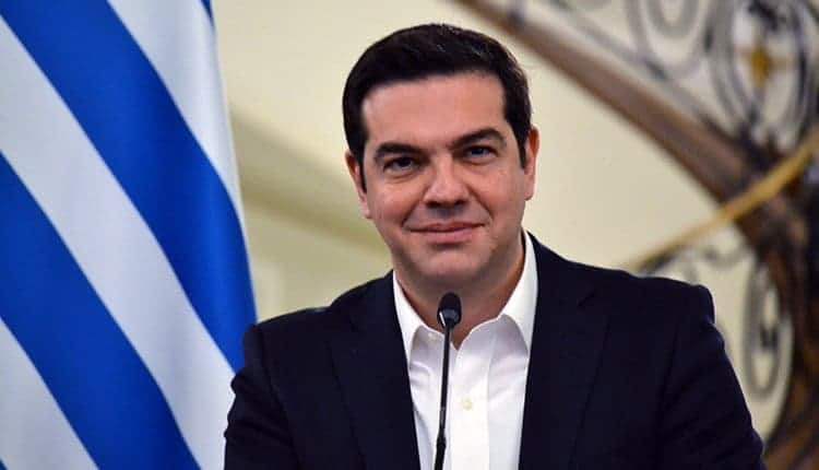 alexis-tsipras with greek flag behind