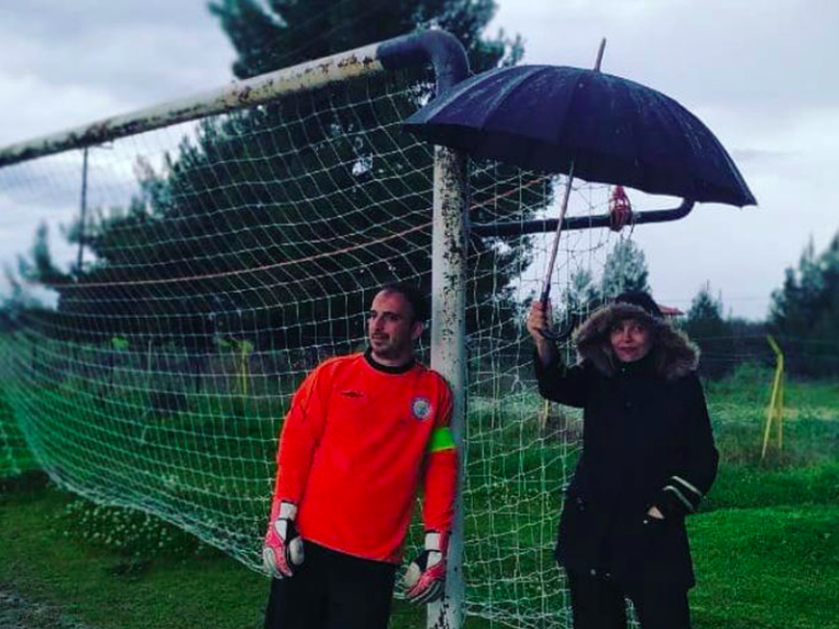 Photo of Greek Mum holding umbrella during her son’s soccer game goes viral