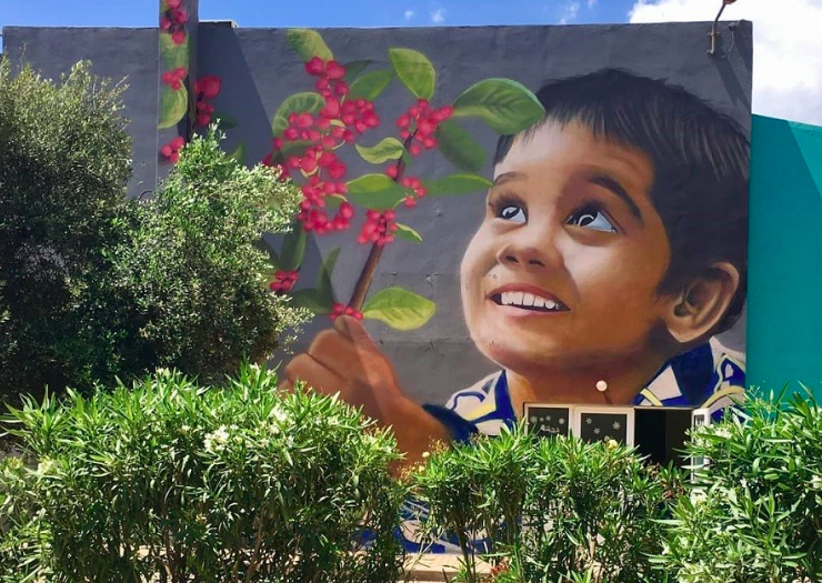 Greek graffiti artist paints face of young child with 102 hearts representing victims who lost their lives in Mati 23
