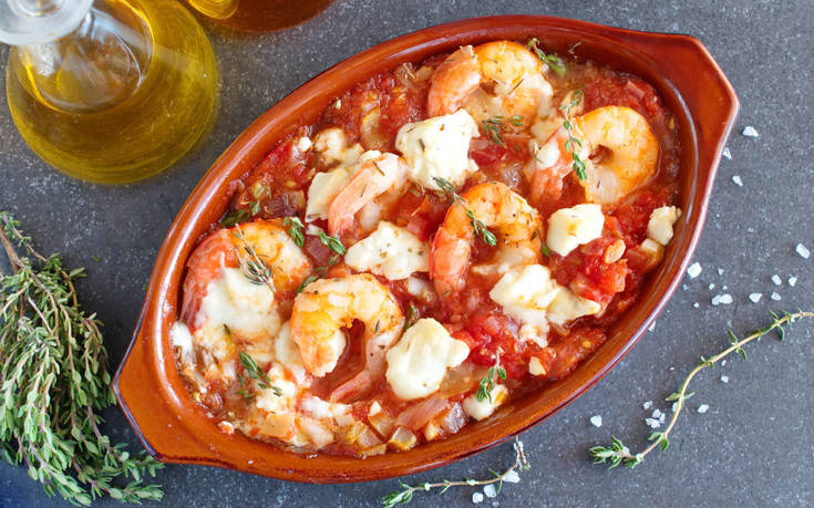 Prawn Saganaki is Greece’s famous seafood dish featuring prawns drenched in a fresh juicy tomato sauce and melted Feta cheese.