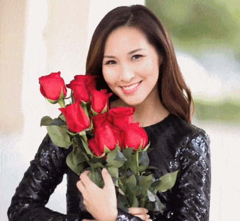 Lady holding long stem red roses