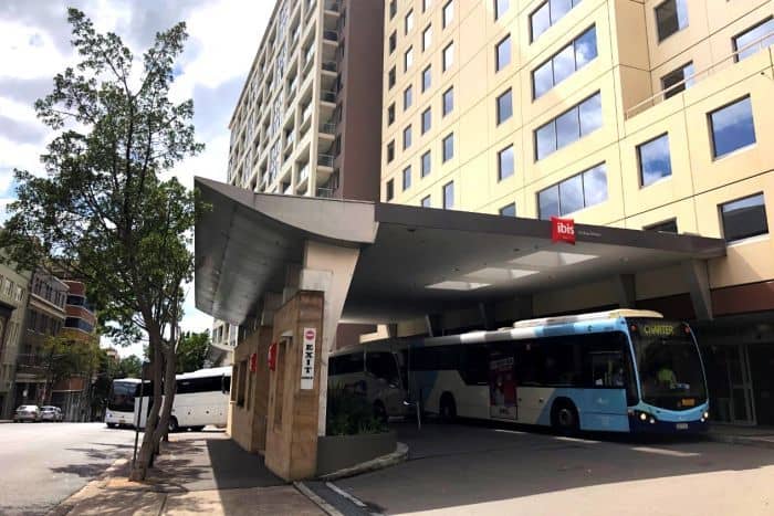 Buses queue to let passengers off into forced quarantine at the IBIS Hotel, Pyrmont, Sydney