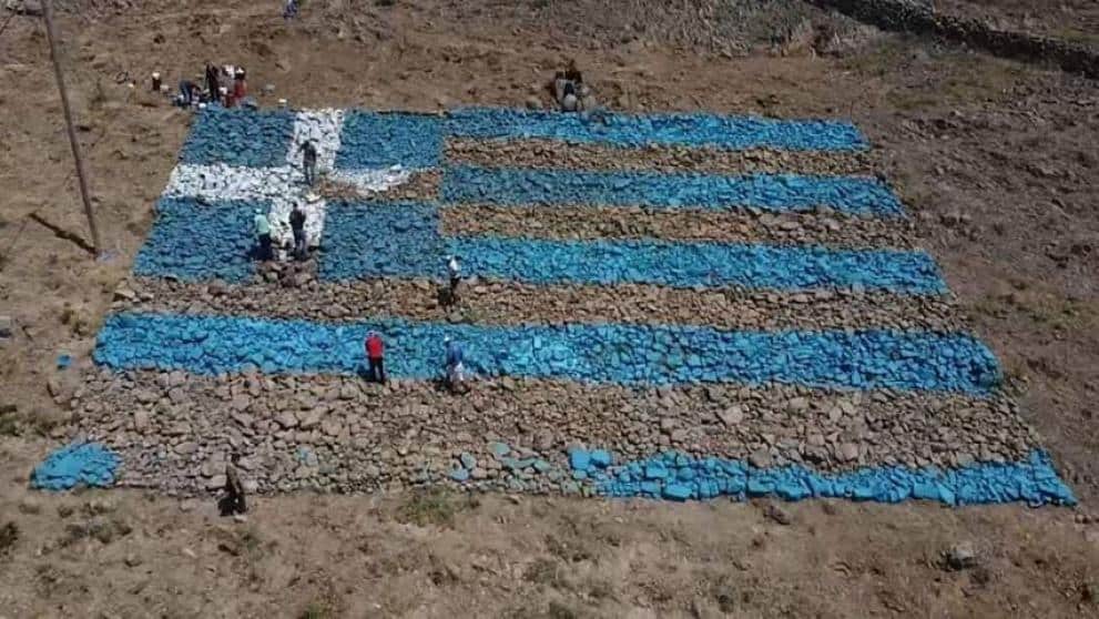 Agra, a village in Lesvos, create a Greek flag from stones