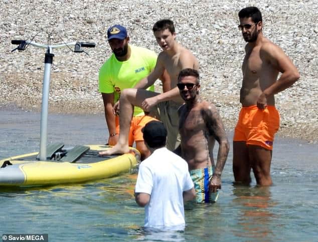 David Beckham hits the beach with his sons in Greece