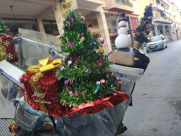 Man in Patras decorates motorcycle with Christmas decorations