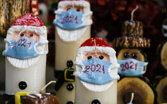 Greek candlemaker masks up Santa Claus and Snowman candles