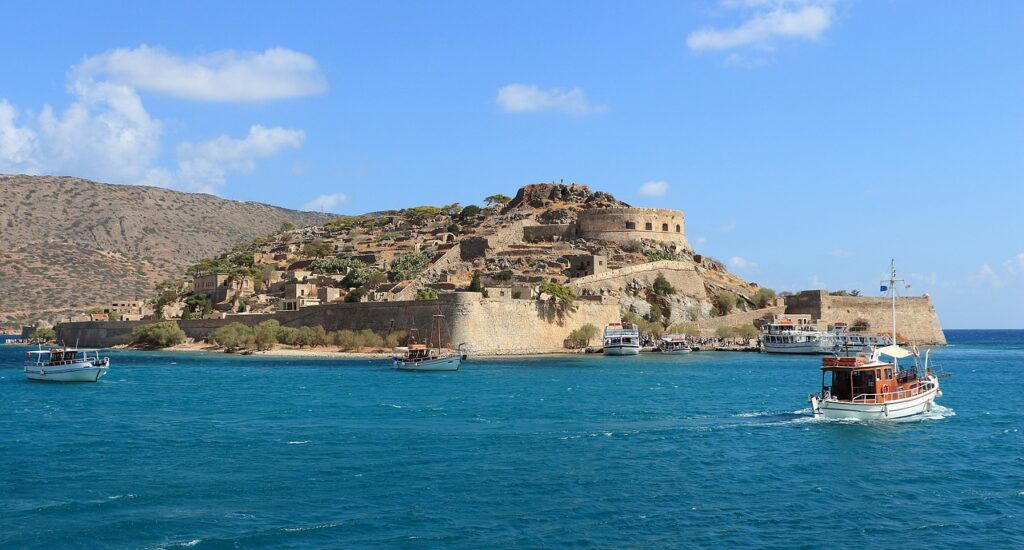 You can freely hop to the isle of Spinalonga 