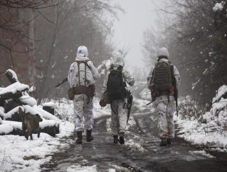 Ukrainian soldiers walks at the line of separation from pro-Russian rebels near Katerinivka, Donetsk region, Ukraine, Tuesday, 7 December 2021. AP/Andriy Dubchak