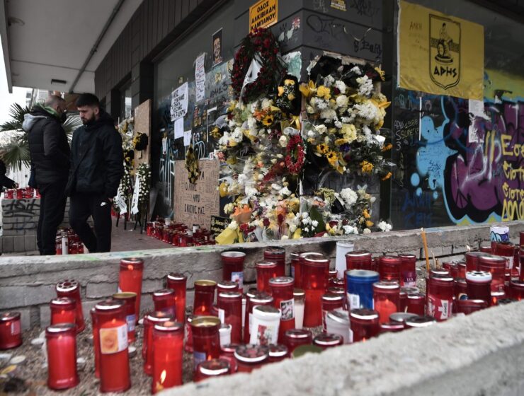 People stand at the spot where a teenager was stabbed to death outside the Aris FC stadium, Thessaloniki, Greece, Feb. 7, 2022. (AFP Photo) draft bill