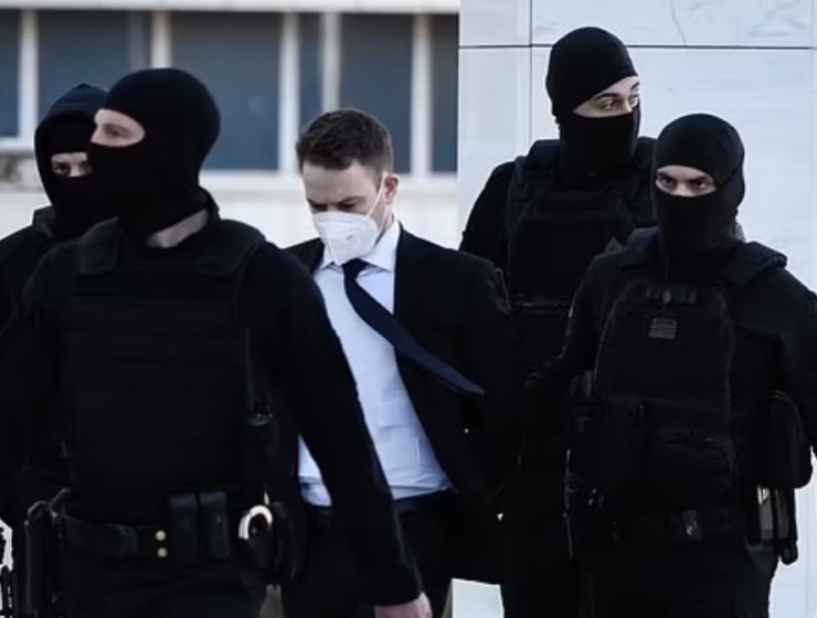 Flanked by cops, Babis Anagnostopoulos (centre) wore a bulletproof vest to court on April 8, 2022.