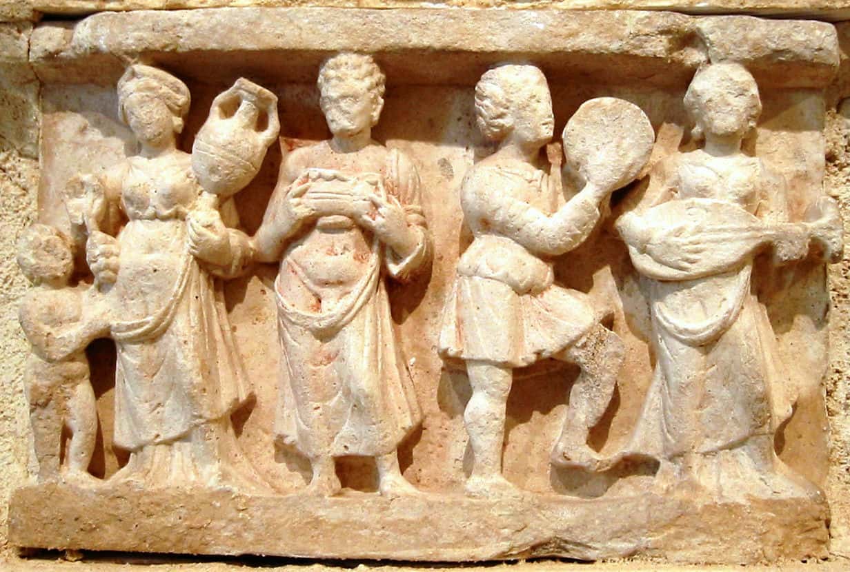 Hellenistic culture in the Indian subcontinent: Greek clothes, amphoras, wine and music. Detail from Chakhil-i-Ghoundi Stupa, Hadda, Gandhara, 1st century AD.