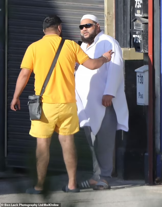 The bearded sex offender was seen walking down the road in his skull cap and a matching while shalwar kameez top and trousers