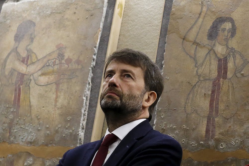 Dario Franceschini in front of frescoed slabs