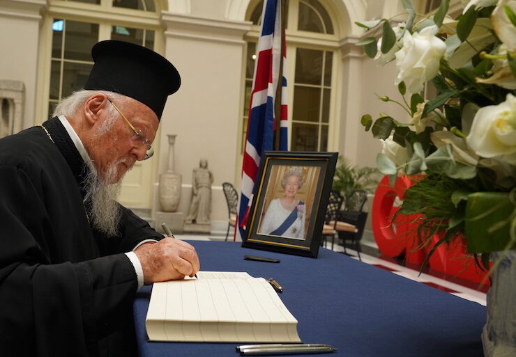 Ecumenical Patriarch Bartholomew signing the condolence book for the Queen at the UK consulate in Istanbul.