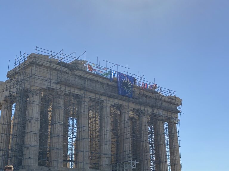 Man climbs Parthenon and threatens to plunge to his death after hanging Greek flags