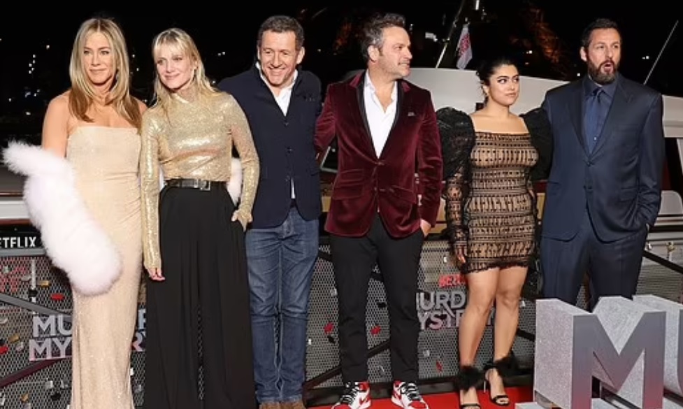 In a snap with her cast members, the actress was also wearing a chic furry jacket. Pictured: Jennifer Aniston, Mélanie Laurent, Dany Boon, Jeremy Garelick, Kuhoo Verma and Adam Sandler