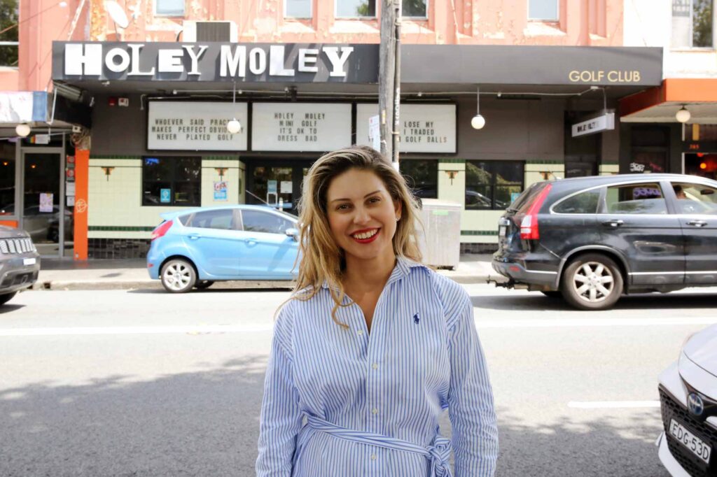 Ms Fiona Douskou, Liberal Candidate for Newtown, is pictured in front of a local party hot-spot called Holey Moley on the busy King St, Newtown.