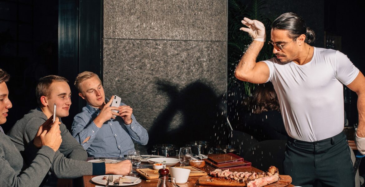 Mr. Gokce performing his signature salting technique at Nusr-Et steakhouse in Manhattan. He is what everyone in the dining room has come to see (and capture on camera).Credit...Cole Wilson for The New York Times Salt Bae