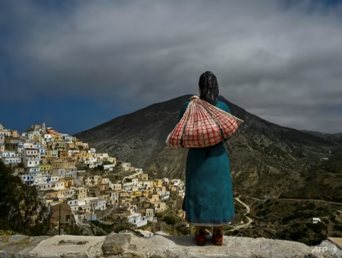 Lord of all she surveys: A sculpture of a woman in traditional costume in Olympos on the Greek island of Karpathos. (Photo: AFP/Louisa Gouliamaki)