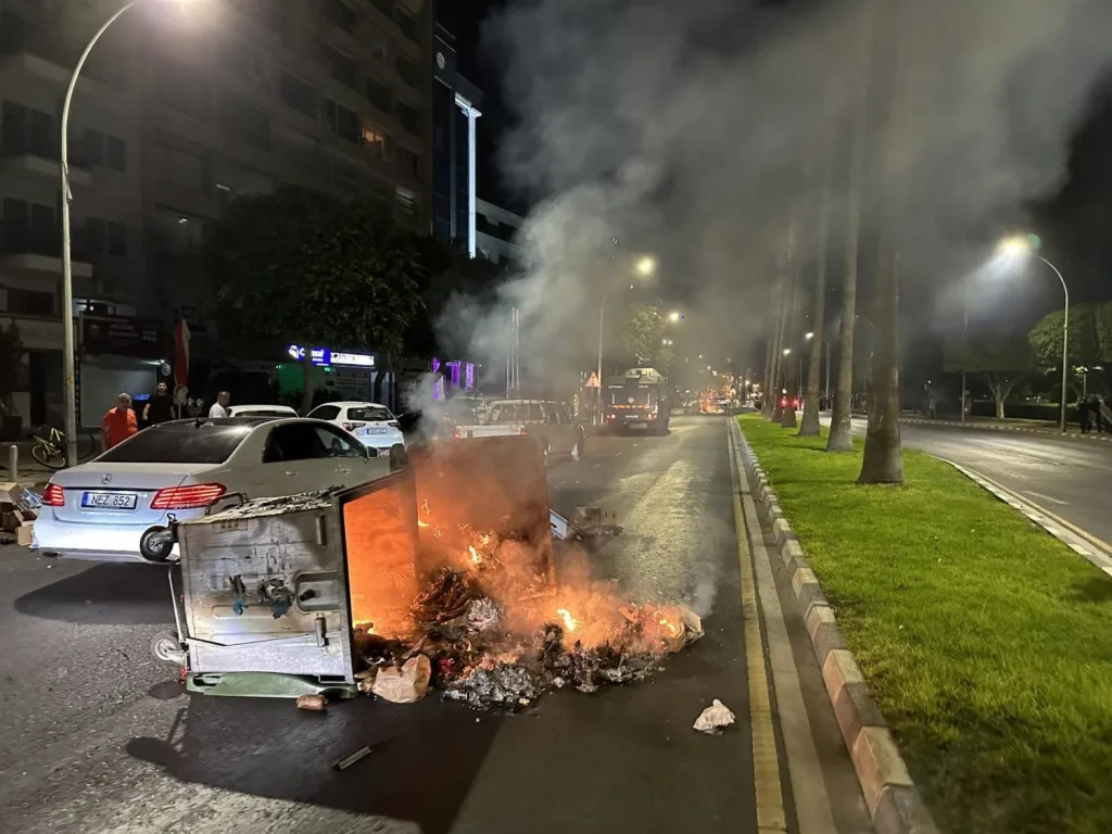 Protestors in Limassol set fire to a garbage bin.