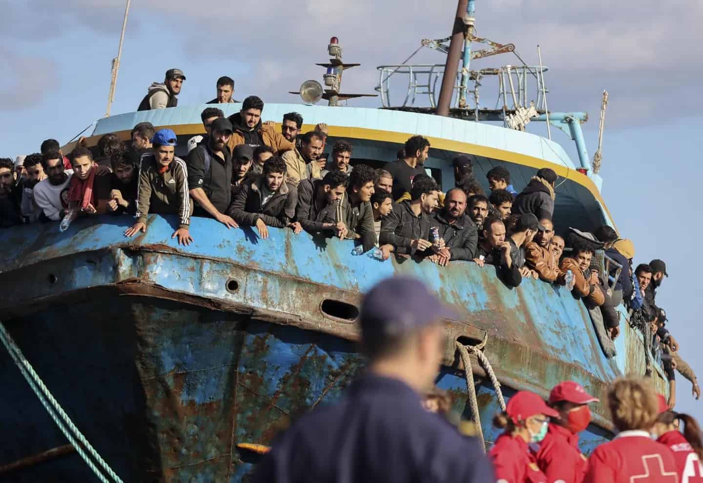 migration Migrants looking out of a fishing boat docked in Palaiochora in Crete, Greece on November 22, 2022.
