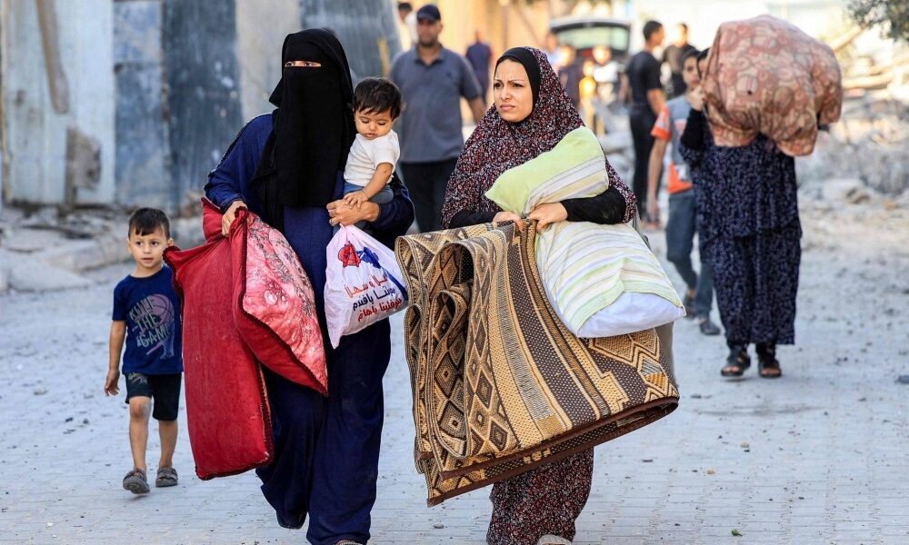 Palestinian refugees flee to Rafah, in southern Gaza, after Israeli airstrikes on October 14.