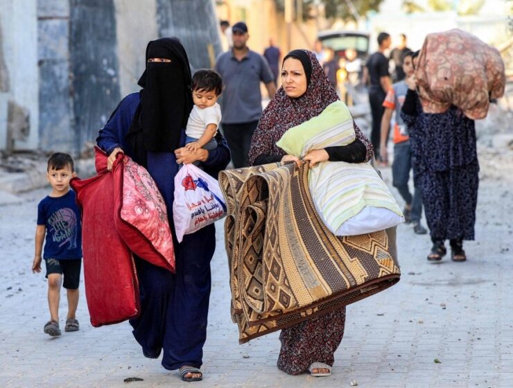 Palestinian refugees flee to Rafah, in southern Gaza, after Israeli airstrikes on October 14.