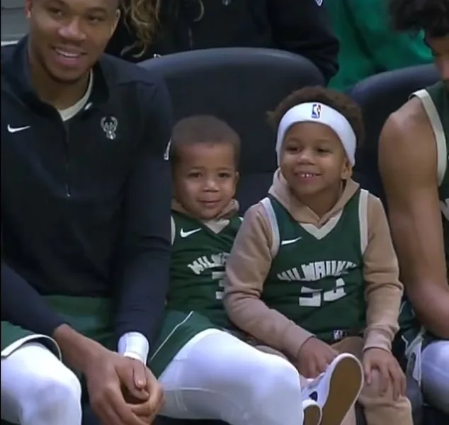 Giannis Antetokounmpo brings his kids onto the bench during the Bucks