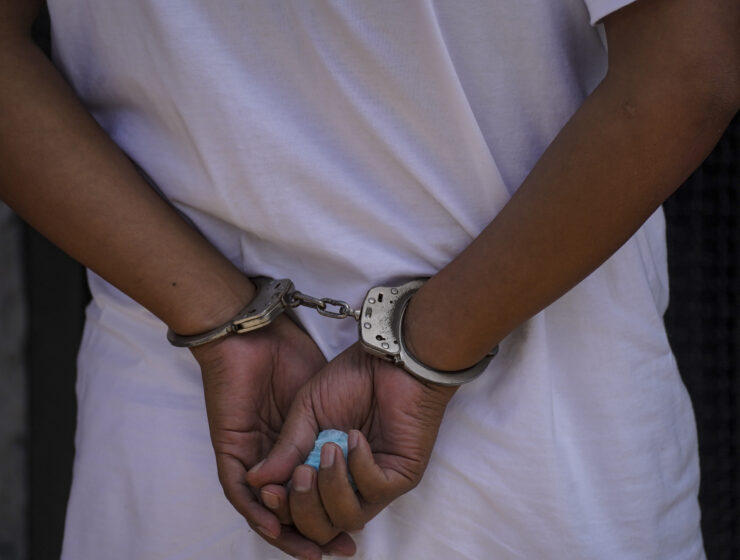 Pakistani arrested handcuffed