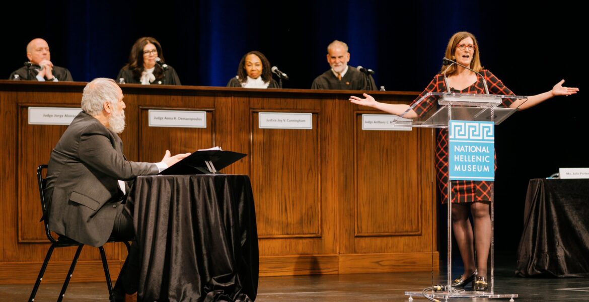 2_Prosecution attorney Julie Porter (right) questions Socrates (seated), played by Second City alum John Kapelos, at the National Hellenic Museum's The Trial of Socrates_Image courtesy of the museum