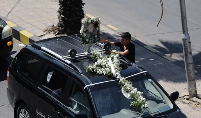A vehicle carries the casket of a victim of a suicide bombing at the Mar Elias Church on Sunday, in Damascus