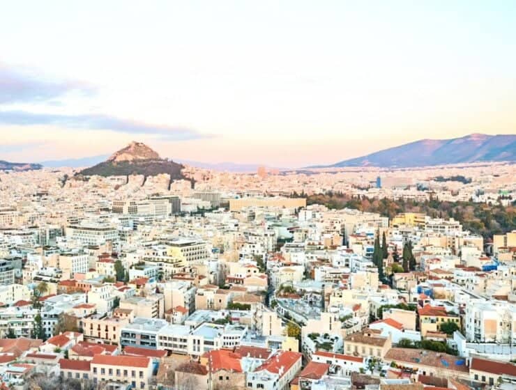 The Acropolis in Athens, a cornerstone of Greece’s cultural heritage, glows at sunset with ancient Parthenon columns