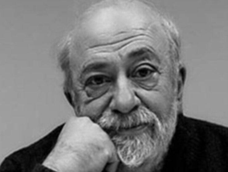 Master Filmmaker Pantelis Voulgaris. B&W image of a bald man with a gray beard wearing a black sweater