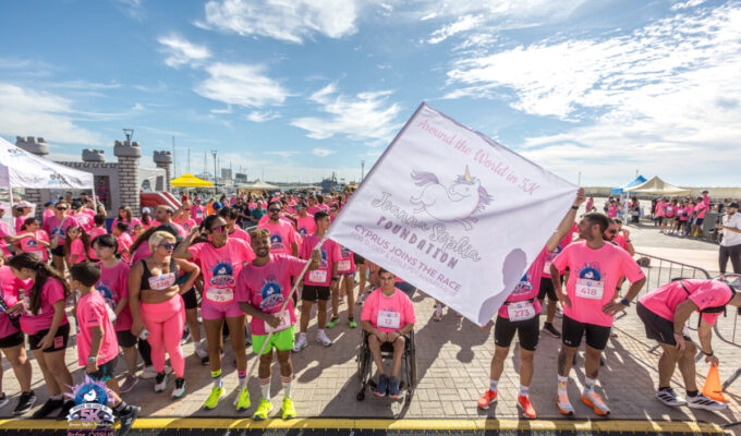 Starting line at Joanna Sophia Foundation Fun Run/Walk. Image of people in pink tshirts holding a flag