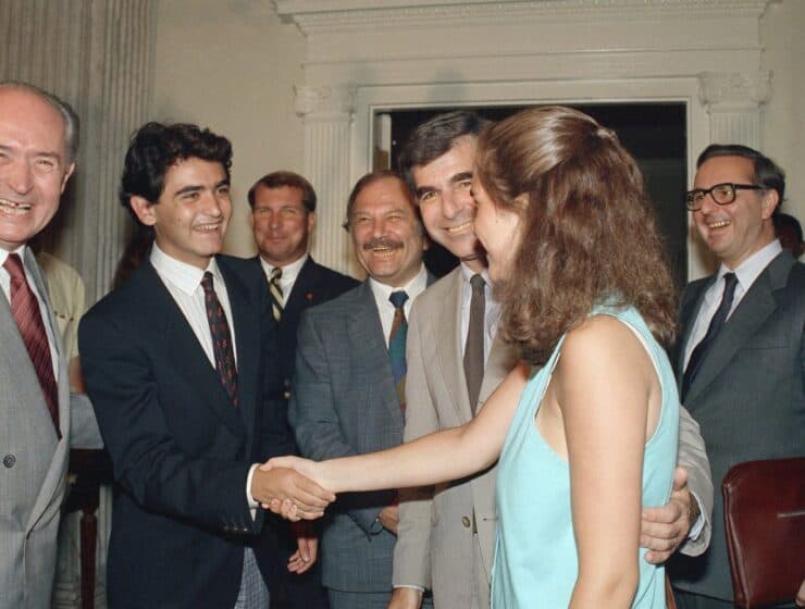 FILE -Cyprus President George Vassiliou, left, smiles as his son Evelthon, 17, is introduced to the daughter of Massachusetts Governor and Democratic presidential nominee Michael S. Dukakis, Kara, 19, at the Statehouse in Boston on Aug. 3, 1988 as Dukakis, second from right looks on, during a visit by the Cyprus President to Boston. (AP Photo/Carol Francavilla, File)
